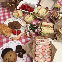 an assortment of pastries and desserts on a table with red checkered cloth