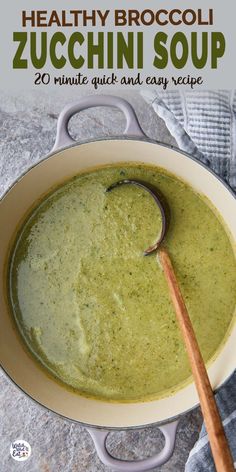 broccoli zucchini soup in a white bowl with a wooden spoon