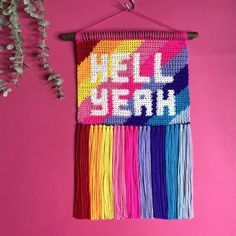 a colorful wall hanging with the words mell sewn on it and some flowers