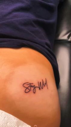 a woman's stomach with the word stay wild written in cursive writing