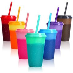 there are many different colored cups with straws