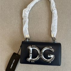 Brand New, Never Worn, Original Tags Attached Dolce & Gabbana Calfskin Phone Bag. Navy And White With Silver Hardware. Adjustable Shoulder Strap Can Be Worn Single Or Doubled. Snap Flap Closure. Silver Tone Hardware And Baroque Logo. Last 3 Photos On Model Are Just For Reference To See How Bag Can Be Styled. Designer Crossbody Evening Bag, Designer Evening Bag With Adjustable Strap, Blue Luxury Evening Bag With Detachable Handle, Luxury Blue Evening Bag With Detachable Handle, Designer Blue Evening Bag, Luxury Blue Evening Bag With Detachable Strap, Luxury Blue Evening Bag, Dolce And Gabbana Perfume, Painted Handbag