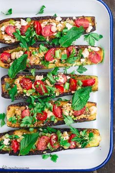 grilled eggplant, tomato and feta salad with fresh herbs on top