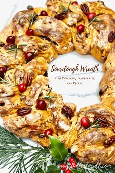 a christmas wreath made out of bread with cranberries and pecans