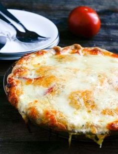 a cheese pizza sitting on top of a black plate