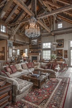 a living room filled with lots of furniture and a chandelier hanging from the ceiling