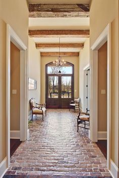 an entry way with two chairs and a chandelier