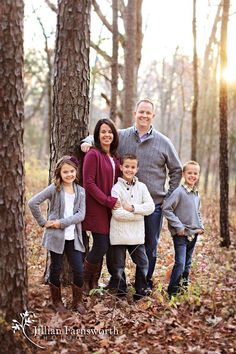 a family standing in the woods with their names written on it and trees around them