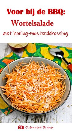 a bowl filled with shredded carrots on top of a table