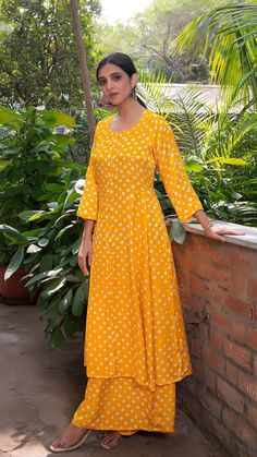 Bring on the festive spirit with our bandhani kurta set. Hand Tie Dyed. Made in modal silk. Flared Kali Kurta with Pallazo Pants. Colour : Yellow. Model height is 5.3” and is wearing a size S. Wash Care : Dry Clean Only. Bandhani Kurta, Silk Kurta Set, Hand Tie, Silk Kurta, Sunshine Yellow, Kurta With Pants, Colour Yellow, Pakistani Outfits, Kurta Set