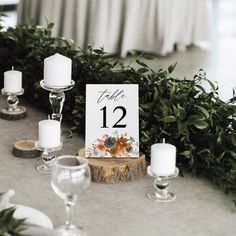 the table is set with candles and place cards