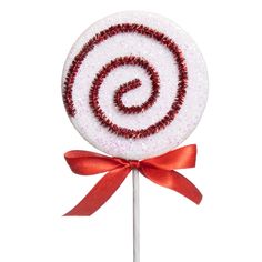 a candy lollipop with a red bow on it's top and the letter g in the middle