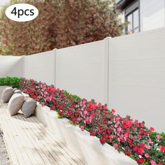 an outdoor garden with flowers and rocks on the ground next to a white fence that says 4 pcs