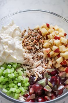 a bowl filled with apples, celery, and other ingredients to make an appetizer