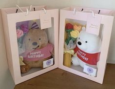 two pink boxes with stuffed animals in them