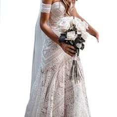 a woman in a wedding dress holding a bouquet