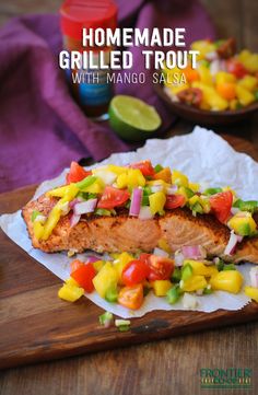 grilled salmon with mango salsa on a cutting board