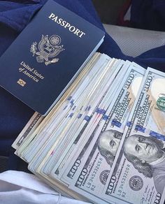 a passport sitting on top of a pile of money