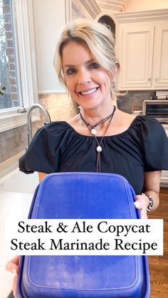 a woman holding a blue tray with the words steak & ale copycat steak marinade recipe