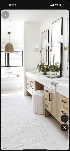 a large bathroom with two sinks and mirrors