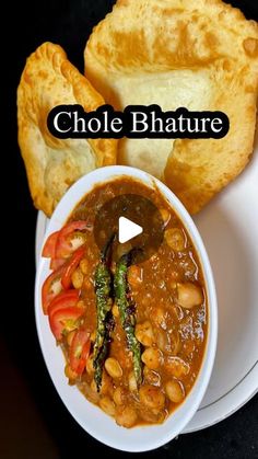 a bowl filled with soup next to bread on top of a white plate and the words choe bhature