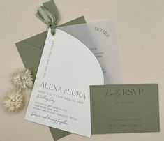 the wedding stationery is laid out on top of each other, including an envelope