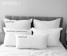 three pillows on top of a bed with white sheets and pillow cases next to each other