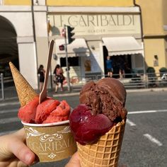 two scoops of ice cream in front of a building