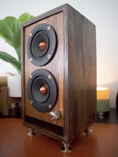 a wooden speaker sitting on top of a table