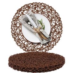 a plate with two forks and knifes on it next to a place setting made out of woven material