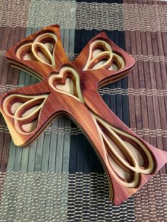 a wooden cross sitting on top of a rug