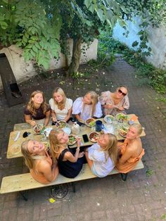 a group of people sitting around a picnic table