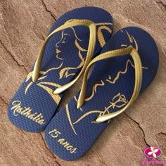 a pair of blue and gold flip flops with the words cinderella written on them