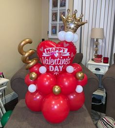 a valentine's day balloon tree with a crown on top