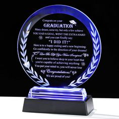 a blue glass plaque with an inscription on it that reads congratulations to someone who is graduating