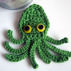 an octopus made out of crochet sitting on top of a table