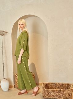 "PRODUCED in 3-5 days FAST & FREE shipping with DHL Express Courier -10% for all items with code \"FAVOURITE\" Buttoned sleeves trousers with an elastic waist in a moss green hue is made for your comfort and style. Create ambitious outfits with this unique linen piece and leave an unforgettable impression. Details: - 100% Linen - Pure linen fabric - Elastic waistband - Straight cut - Buttoned sides - Ankle length - Model's height is 178 cm / 5'10'' wears size M - Code: E3014-L532-161 The trousers are available in other colors. You can find them in the gallery. If you want to order the trousers in another color, please specify it in the personalization field. Sizing: This garment is true to size, and we recommend choosing the size you usually wear. If you want the garment to be loose-fittin Green Linen Trousers, Linen Inspiration, Khaki Linen Pants, Pants Elastic Waist, Plus Size Kleidung, Linen Trousers, Style Expert, Moss Green, Pure Linen