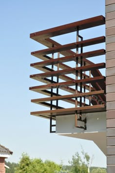 a bird feeder hanging from the side of a building