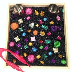 a pair of scissors and some beads in a box