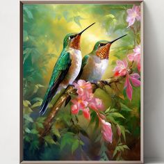 two hummingbirds sitting on a branch with pink flowers