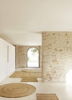 an empty room with round rugs on the floor