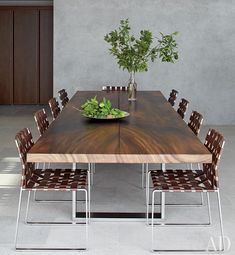 a wooden table sitting next to a potted plant on top of a metal shelf