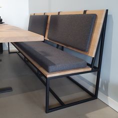 a wooden table with two chairs and a bench in front of it on the floor