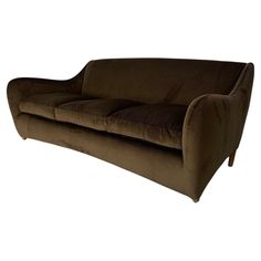 a brown couch sitting on top of a white floor