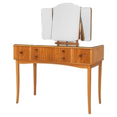 a wooden dresser with a mirror on top of it and drawers under the mirror, against a white background