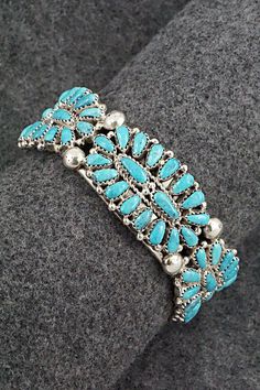 This turquoise and sterling silver bracelet was made by Navajo silversmith Jaz Wilson. The inside is signed J Wilson and S/S.Size: 5 3/4" (will fit up to a 6 1/2" wrist)Gap: 3/4"Width: 7/8"Free shipping on all orders! We ship with USPS and always include tracking. All orders ship within a day of payment.Returns are accepted up to 30 days after you receive your order. Just send us a message. Our shop offers cash back or store credit. The item must be returned in new condition. Southwestern Style Sterling Silver Bracelet, Southwestern Silver Hand-strung Bracelets, Southwestern Style Turquoise Inlay Bracelets, Southwestern Turquoise Inlay Bracelet, Sterling Silver Bracelet, Holiday Sales, Turquoise Sterling Silver, Green Bay, Sterling Silver Bracelets