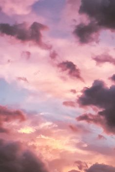 the sky is pink and purple with clouds