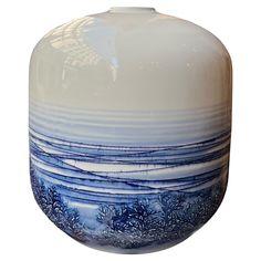 a blue and white vase sitting on top of a table