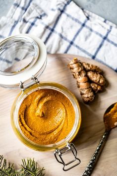 a jar filled with peanut butter next to some ginger