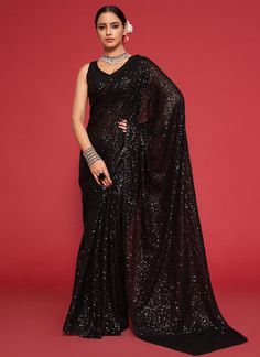 Elegantly stunning, this designer georgette saree features intricate black sequins and thread work that exudes a sense of sophistication and luxury. Perfect for a reception or festive party, this saree will make you stand out and leave a lasting impression. Ideal as a gift for your girlfriend, it is sure to make her feel special and glamorous. The unstitched blouse can be customized upto 42 inches. Do Note: All the accessories shown are for styling purpose only. Slight color variation may occur Black Sequin Saree, Sequins Saree, Pure Georgette Sarees, Sequin Saree, Party Sarees, Party Wear Saree, Black Saree, Wear Saree, Georgette Saree